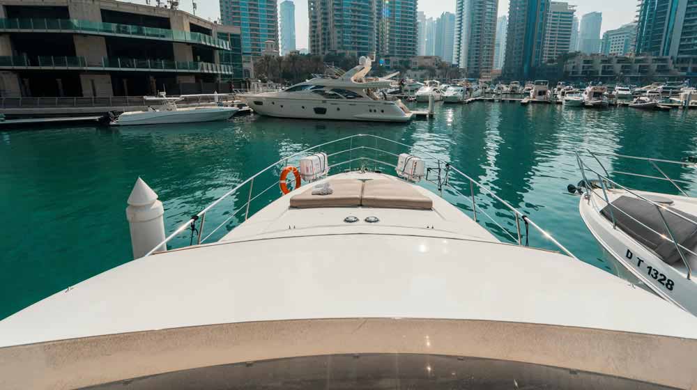 yacht front deck with sun beds and docked at dubai marina